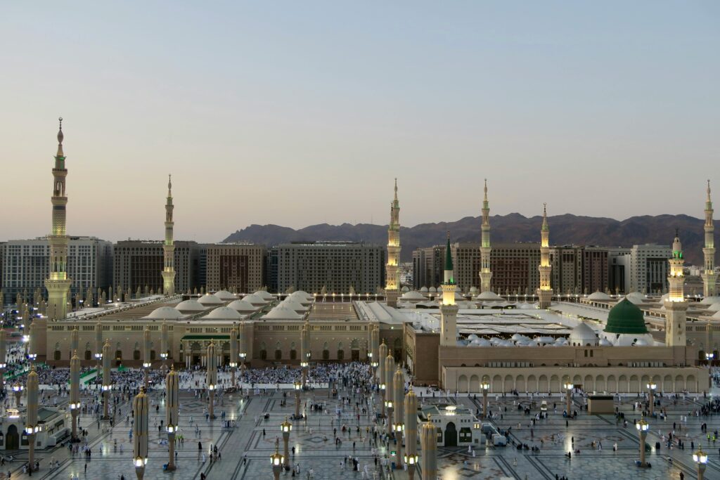Stunning aerial image of Al-Masjid an-Nabawi in Medina, KSA at dusk, showcasing Islamic architecture.
